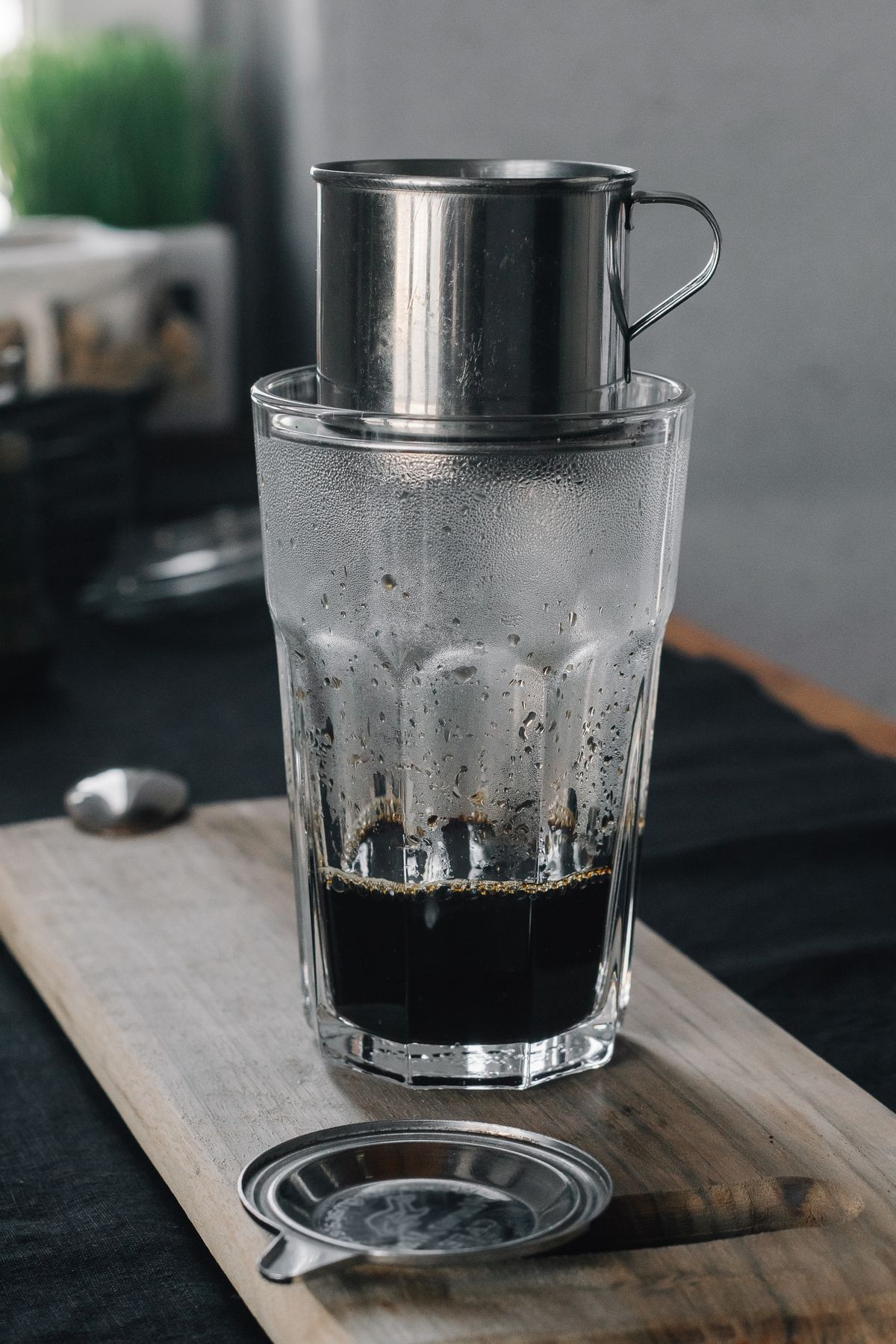 Vietnamese coffee brewing through a metal phin into a glass